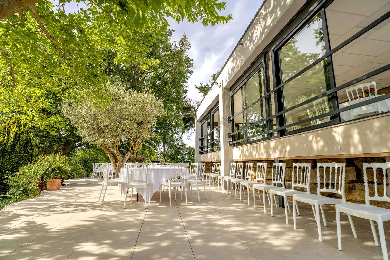 The reception terrace in the shade of the trees